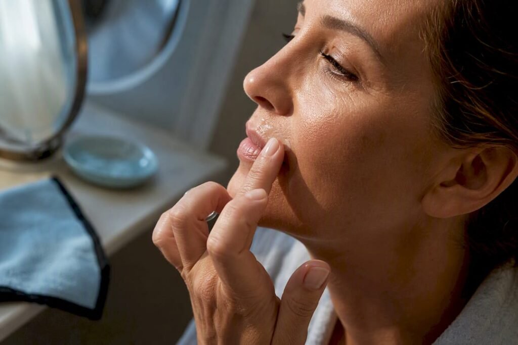 Woman applying treatment around upper lip lines